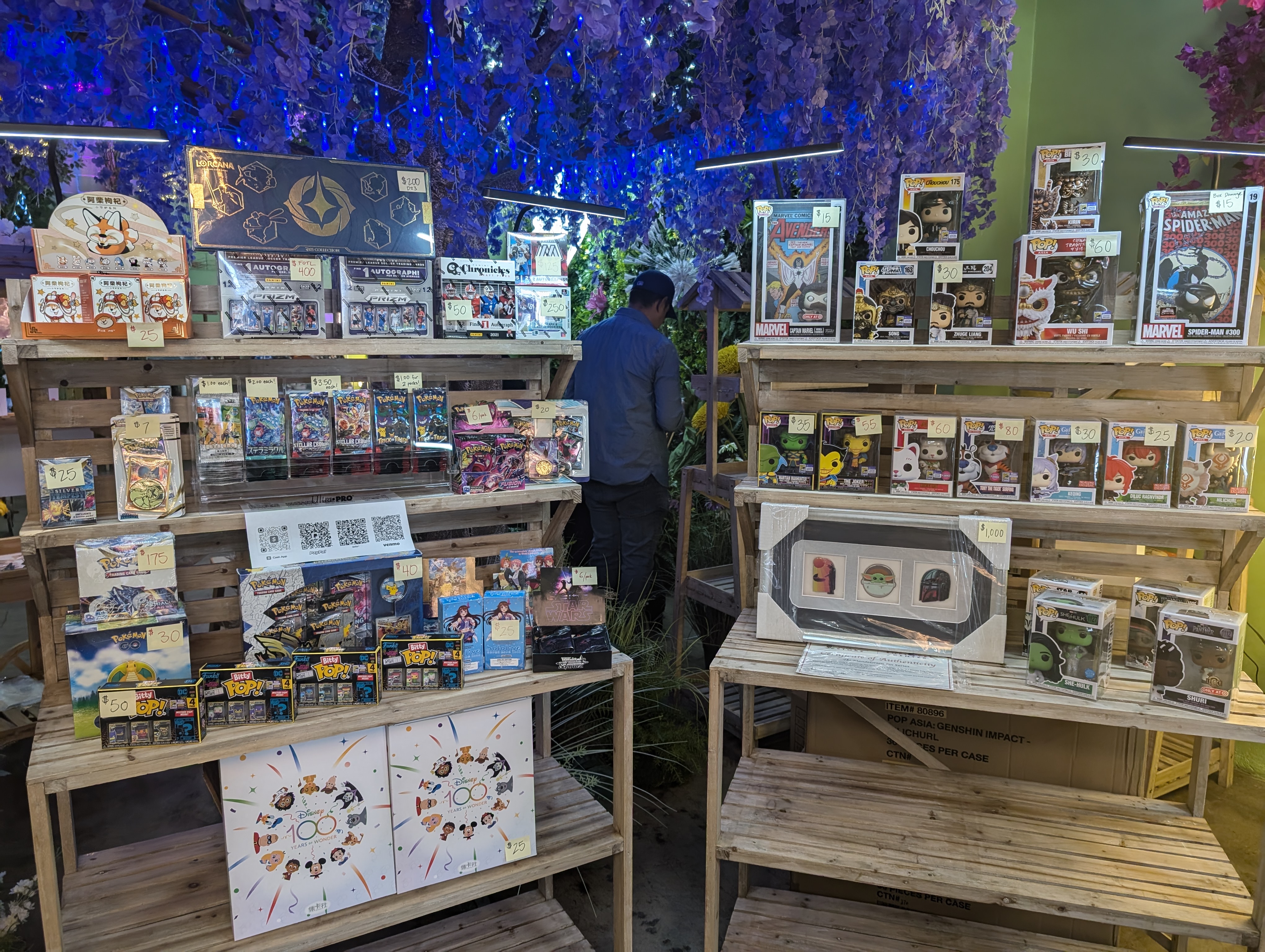 Blue-lit collectibles display at Happy Humble Hub