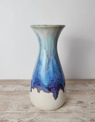 Handmade white ceramic vase with flowing blue glaze