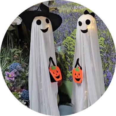 Two smiling Halloween ghost decorations holding orange pumpkin baskets