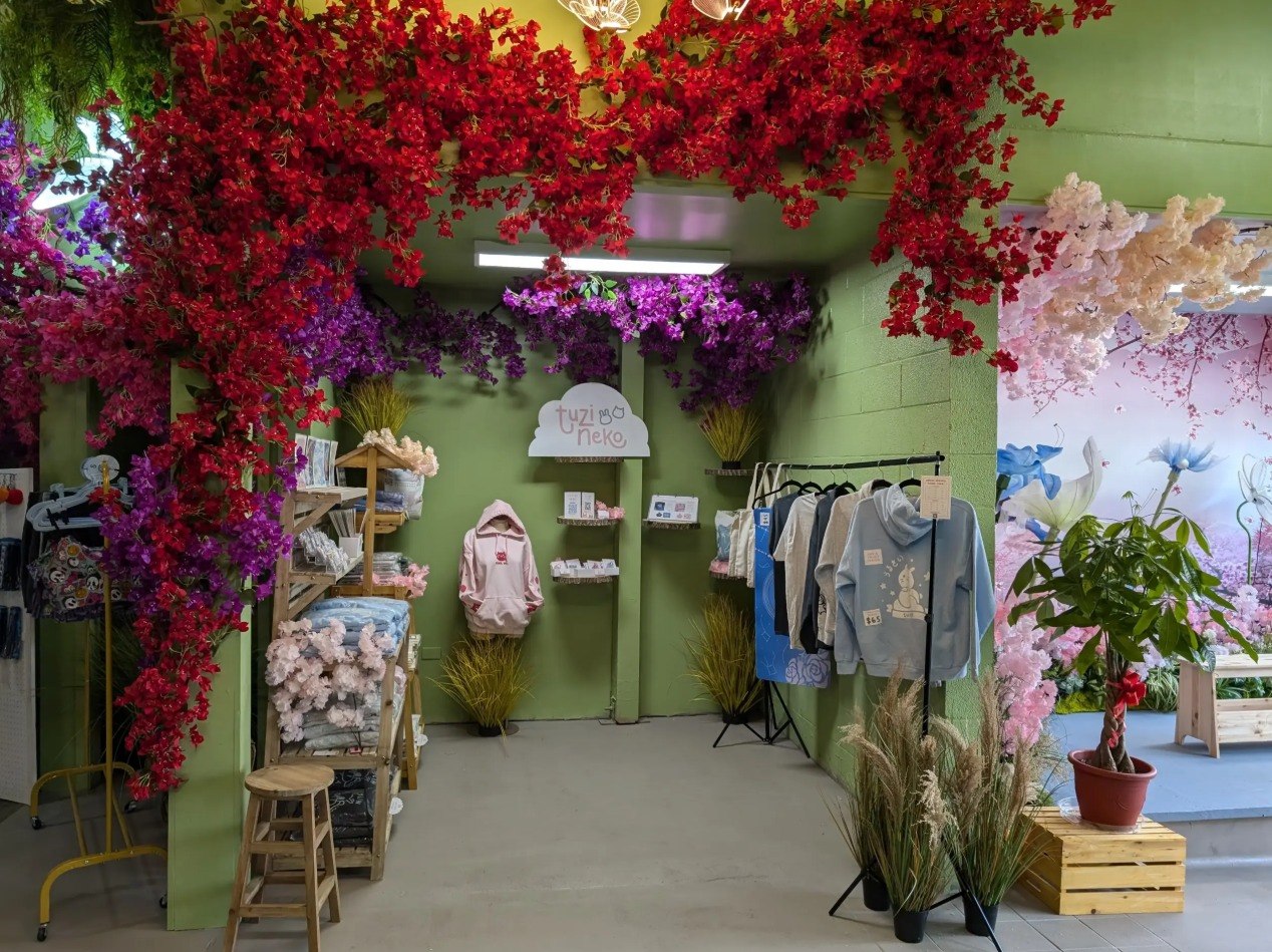 Happy Humble Hub Village Shops interior with vibrant floral displays and vendor merchandise